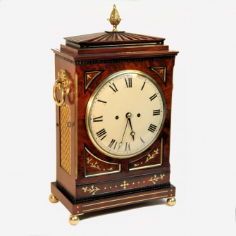 A good Regency, gadrooned chamfer top bracket clock in an elaborate mahogany case. Circa 1815.