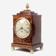 A small mahogany, late Georgian, chamfer-top table clock with a fusee timepiece movement. Circa 1835