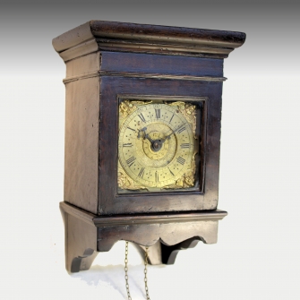 A rare, 17th century, early English hooded wall clock in an oak case with a timepiece Alarum movemen