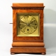 English 5 glass, satinwood library clock with a chain fusee movement and engine turned gilded dial. 
