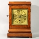 English 5 glass, satinwood library clock with a chain fusee movement and engine turned gilded dial. 