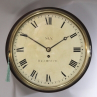 An early, wooden dial, English dial wall clock in a mahogany case. Made by Sly, Weymouth. Circa 1815