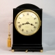 A good, small, Regency table clock in an ebony veneered case. By Louis Recordon, circa 1820.