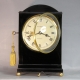 A good, small, Regency table clock in an ebony veneered case. By Louis Recordon, circa 1820.