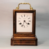French, bell striking mantel clock in an inlaid rosewood case. Made by Paul Garnier. Circa 1870.
