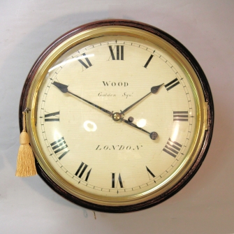 Early English fusee dial clock with a wooden convex dial and sheraton style bezel. Circa 1820.