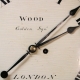 Early English fusee dial clock with a wooden convex dial and sheraton style bezel. Circa 1820.