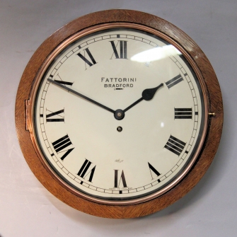 Oak cased wall 'dial' clock with lever escapement, by Elliott. A rare style. Circa 20th ce