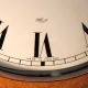 Oak cased wall 'dial' clock with lever escapement, by Elliott. A rare style. Circa 20th ce